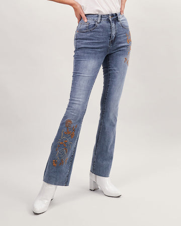Light blue washed flared jeans with brown floral embroidery