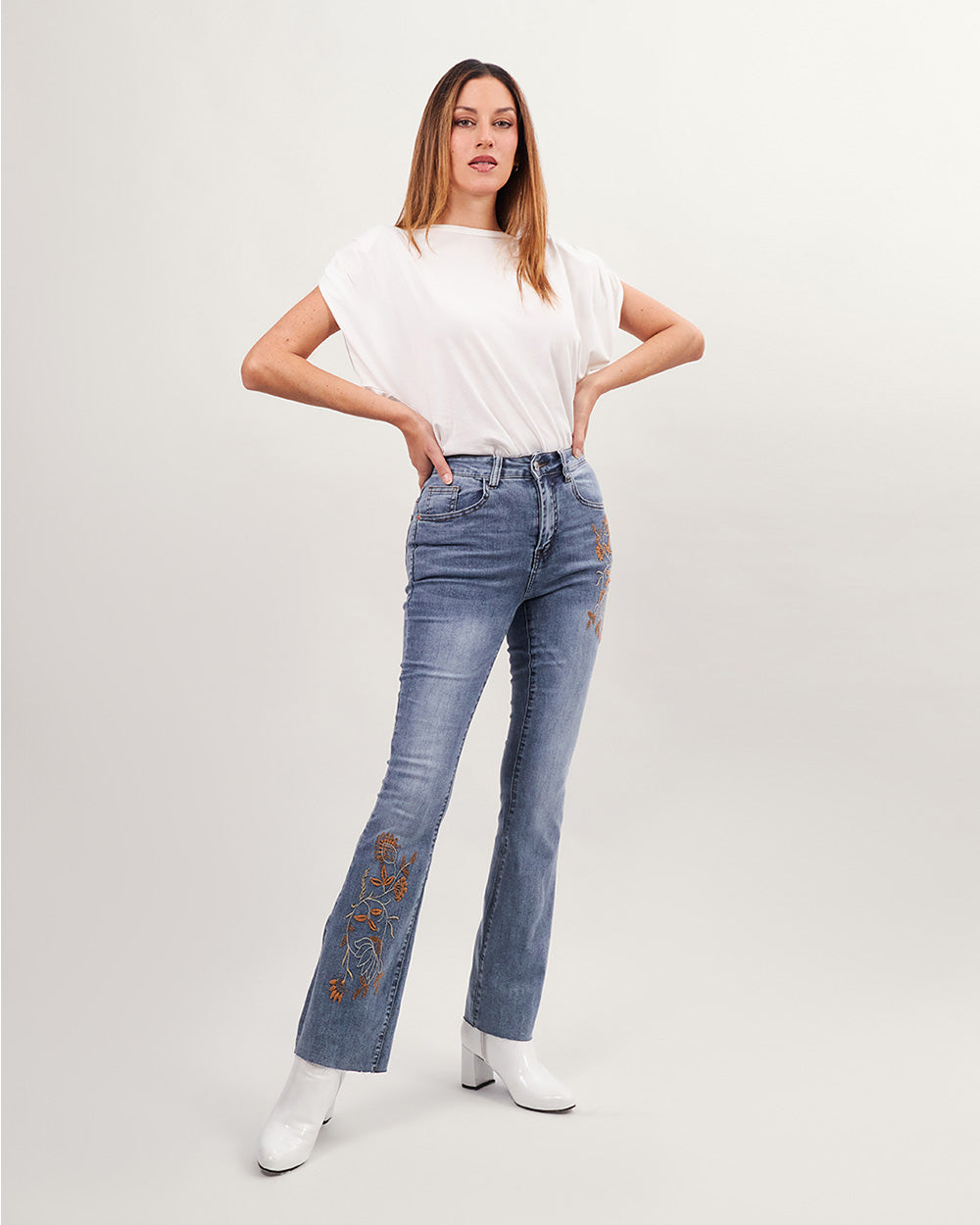 Light blue washed flared jeans with brown floral embroidery
