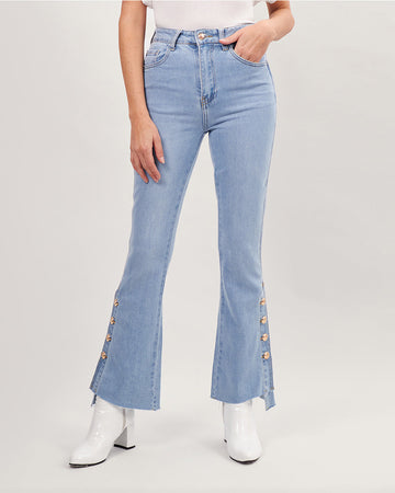 Light blue flared jeans with gold buttons at the bottom